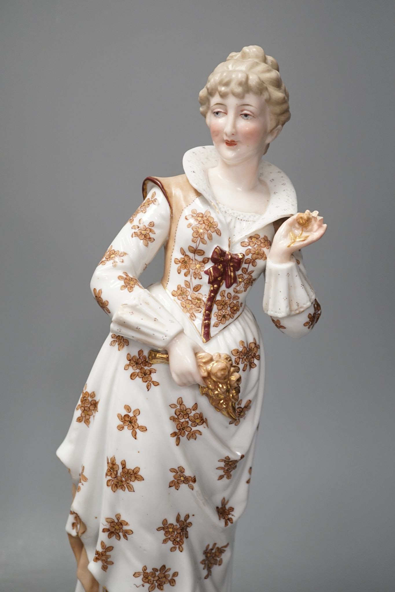 A pair of large French porcelain figures, 38cm, and a figural group en suite